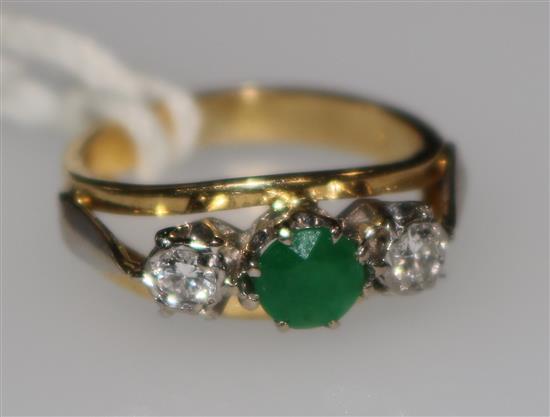 A gold and three stone emerald and diamond ring, size G.